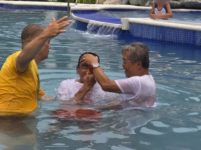 Pastor Ric baptizing a new believer in water